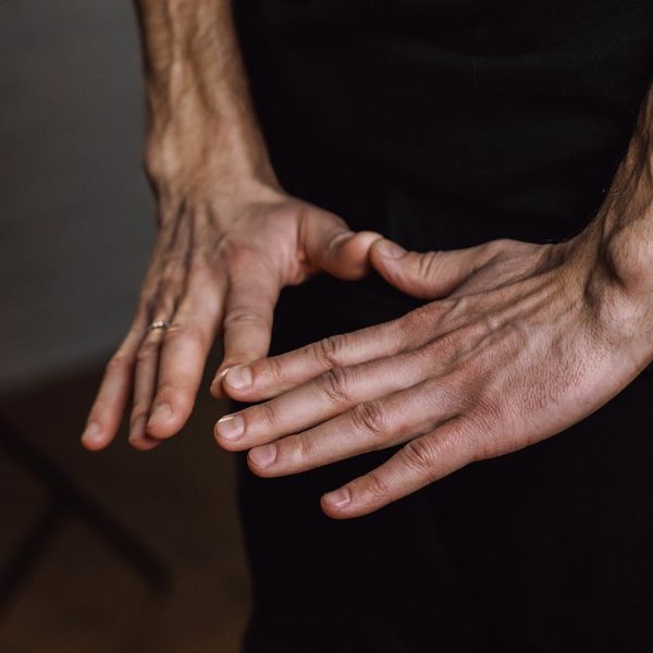 Close up of a person's hands in a meditative mudra gesture.
