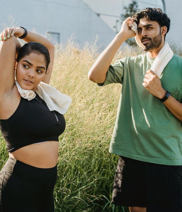 Person stretching outdoors at sunrise, symbolizing renewed energy and vitality.